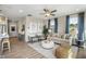 Cozy living room features ample natural light, a ceiling fan, and stylish furniture at 104 Siebold St, Garner, NC 27529