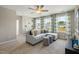 Cozy living room area with comfortable sectional seating, plenty of windows, and neutral decor at 104 Siebold St, Garner, NC 27529
