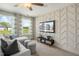 Relaxing living room area with plush seating, large screen television, and designer wall feature at 104 Siebold St, Garner, NC 27529
