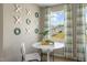 Charming sitting area featuring a marble table, two chairs, a window, and decorative wall art at 104 Siebold St, Garner, NC 27529