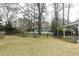 A large backyard featuring a black chain link fence and a two-car carport at 105 John St, Louisburg, NC 27549