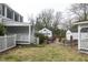 Expansive backyard showcasing a brick patio, detached garage, and mature trees at 105 John St, Louisburg, NC 27549