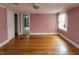 A spacious bedroom with hardwood floors and natural light from the window at 105 John St, Louisburg, NC 27549