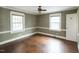 Bedroom with hardwood floors, neutral walls, and large windows that brings in natural light at 105 John St, Louisburg, NC 27549