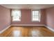 Vacant bedroom with neutral walls, wood floors, and two windows at 105 John St, Louisburg, NC 27549