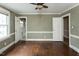 Cozy bedroom featuring hardwood floors, neutral walls, and multiple doorways at 105 John St, Louisburg, NC 27549