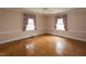 Comfortable bedroom features classic molding, ceiling fan, and hardwood flooring at 105 John St, Louisburg, NC 27549