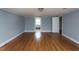 Spacious bedroom featuring hardwood floors, neutral paint, and natural light at 105 John St, Louisburg, NC 27549
