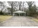 A covered carport with a concrete floor and ceiling fans at 105 John St, Louisburg, NC 27549