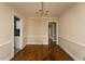Cozy dining room with hardwood floors and classic wainscoting detail, perfect for Gathering meals at 105 John St, Louisburg, NC 27549