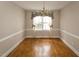 Charming dining room features classic chandelier, chair railing and hardwood floors at 105 John St, Louisburg, NC 27549