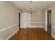Dining room featuring classic chandelier, chair railing and hardwood floors at 105 John St, Louisburg, NC 27549