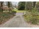 Long driveway leading to the property, surrounded by lush greenery, offering privacy and a grand entrance at 105 John St, Louisburg, NC 27549