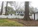 Well-maintained home with a spacious yard, white picket fence, and mature trees at 105 John St, Louisburg, NC 27549