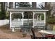 Charming backyard gazebo with lattice details and comfortable seating area on a brick patio at 105 John St, Louisburg, NC 27549