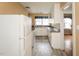 Classic kitchen with white cabinetry and laminate countertops; ample storage space at 105 John St, Louisburg, NC 27549