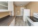 Functional kitchen featuring white appliances, ample counter space and durable flooring at 105 John St, Louisburg, NC 27549