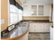 Well-lit kitchen boasts white cabinets, laminate counters and undermount sink at 105 John St, Louisburg, NC 27549