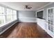 Spacious living room with hardwood floors, a ceiling fan, and a convenient pass-through to the bar area at 105 John St, Louisburg, NC 27549