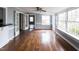 Bright and airy living room featuring hardwood floors and large windows that fill the space with natural light at 105 John St, Louisburg, NC 27549