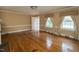 Sunlit living room boasting hardwood floors, a decorative fireplace, and charming window treatments, creating a cozy ambiance at 105 John St, Louisburg, NC 27549