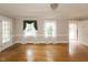 Light-filled living room showcasing hardwood floors and classic architectural details at 105 John St, Louisburg, NC 27549