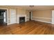 Bright living room with a cozy fireplace, built-in shelving, and hardwood floors, perfect for Gathering gatherings at 105 John St, Louisburg, NC 27549