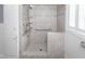 Accessible walk-in shower with gray tile, mosaic accents, shower seat and grab bars at 105 John St, Louisburg, NC 27549
