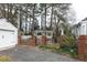Well-maintained yard with a gazebo, brick-columned fence, and a detached garage at 105 John St, Louisburg, NC 27549