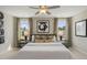 Spacious bedroom with a large bed, stylish decor, and bright windows with patterned curtains at 108 Siebold St, Garner, NC 27529
