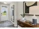 Bright entryway with a dark wood floor, modern console table, and decorative mirror enhancing the welcoming atmosphere at 108 Siebold St, Garner, NC 27529