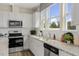 Modern kitchen boasts stainless steel appliances, granite countertops, and ample natural light at 108 Siebold St, Garner, NC 27529