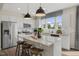 Bright kitchen features white cabinets, stainless steel appliances, and a granite island with seating at 108 Siebold St, Garner, NC 27529