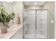 Clean, modern bathroom featuring a glass-enclosed shower, and a sleek double sink vanity with minimalist decor at 112 Siebold St, Garner, NC 27529