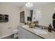 Bathroom featuring a double sink vanity with modern fixtures, a framed mirror, and neutral color palette at 116 Siebold St, Garner, NC 27529