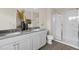 Bathroom featuring dual sinks, granite countertop, and glass-enclosed shower at 116 Siebold St, Garner, NC 27529