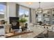 Kitchen island with seating and decorative styling adjacent to dining area and sliding glass door at 116 Siebold St, Garner, NC 27529