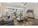 Open concept living space with hardwood floors, large TV, and adjacent kitchen and dining areas at 116 Siebold St, Garner, NC 27529