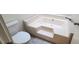 The bathroom features a large corner bathtub, along with a toilet at 12 Melstone Turn, Durham, NC 27707
