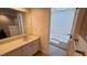 Bright bathroom featuring a vanity with mirror, tub, and updated fixtures at 12 Melstone Turn, Durham, NC 27707