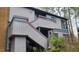View of gray home exterior with red trim and staircase leading to the front door at 12 Melstone Turn, Durham, NC 27707