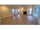 Open living room with modern floors, fireplace, and sliding glass doors leading to outdoor seating at 12 Melstone Turn, Durham, NC 27707