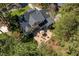 Aerial view of a beautiful home featuring a backyard patio and lush landscaping with mature trees at 1321 Colonial Club Rd, Wake Forest, NC 27587