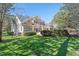 Expansive backyard with lush lawn, mature trees, and a charming patio area for outdoor enjoyment at 1321 Colonial Club Rd, Wake Forest, NC 27587