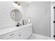 Modern bathroom featuring a white vanity, round mirror, and horizontal shiplap accent wall at 1321 Colonial Club Rd, Wake Forest, NC 27587