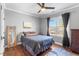 Bedroom with hardwood flooring, ceiling fan, and natural light from the window at 1321 Colonial Club Rd, Wake Forest, NC 27587