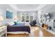 Bright bedroom with tray ceilings, a massage chair, and hardwood flooring at 1321 Colonial Club Rd, Wake Forest, NC 27587
