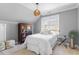 Bright bedroom featuring a light color scheme, large window, and hardwood flooring at 1321 Colonial Club Rd, Wake Forest, NC 27587