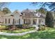 Charming two-story home boasts a manicured lawn and inviting front porch with detailed trim work at 1321 Colonial Club Rd, Wake Forest, NC 27587