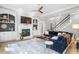 Spacious living room with a fireplace, built-in shelving, hardwood floors, and a large sectional couch at 1321 Colonial Club Rd, Wake Forest, NC 27587